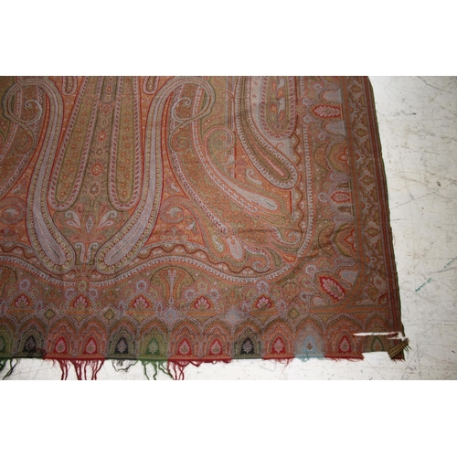 1757 - 19THC PAISLEY SHAWL probably late 19thc, a large Paisley patterned woollen shawl with the remains of... 