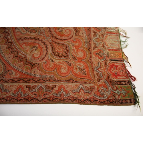 1770 - 19THC PAISLEY SHAWL a woven wool Paisley shawl, with a rich palette of reds, orange and pale green, ... 