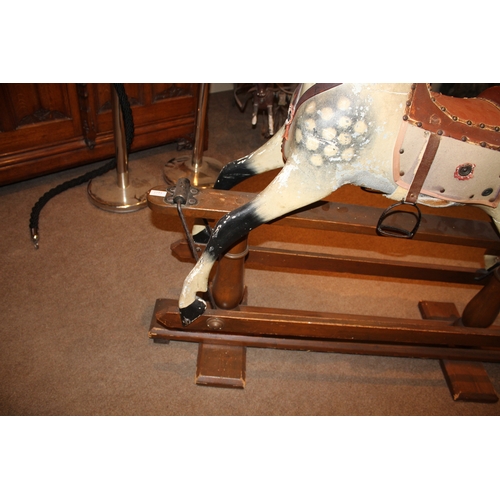 1413 - ANTIQUE ROCKING HORSE a painted wooden rocking horse, fitted with a leather saddle and stirrups and ... 