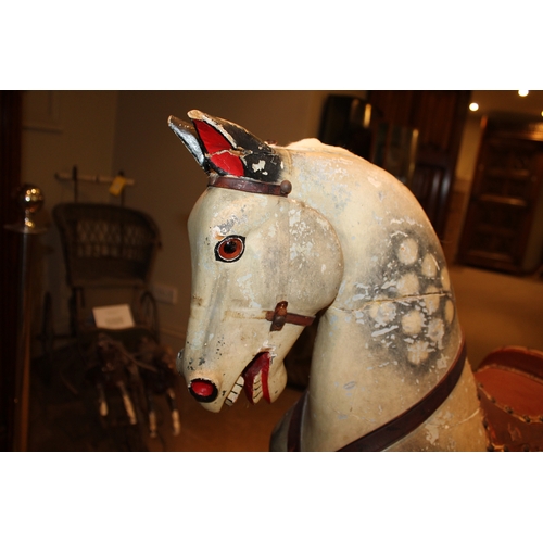 1413 - ANTIQUE ROCKING HORSE a painted wooden rocking horse, fitted with a leather saddle and stirrups and ... 