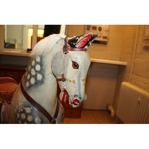 1413 - ANTIQUE ROCKING HORSE a painted wooden rocking horse, fitted with a leather saddle and stirrups and ... 