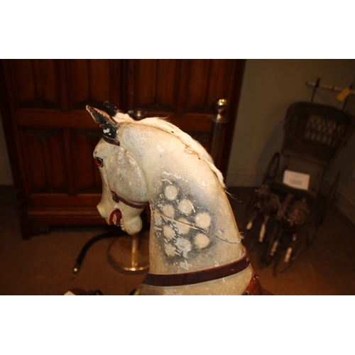 1413 - ANTIQUE ROCKING HORSE a painted wooden rocking horse, fitted with a leather saddle and stirrups and ... 