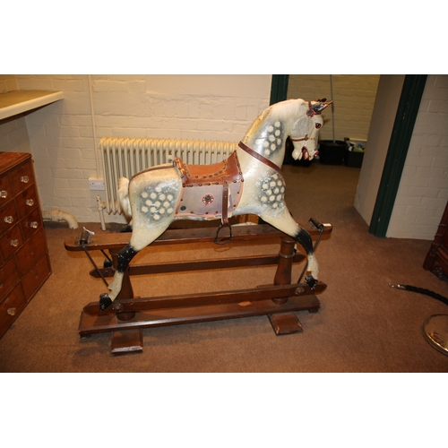 1413 - ANTIQUE ROCKING HORSE a painted wooden rocking horse, fitted with a leather saddle and stirrups and ... 