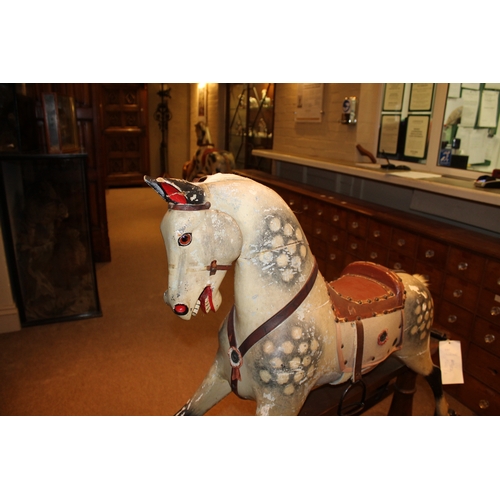 1413 - ANTIQUE ROCKING HORSE a painted wooden rocking horse, fitted with a leather saddle and stirrups and ... 