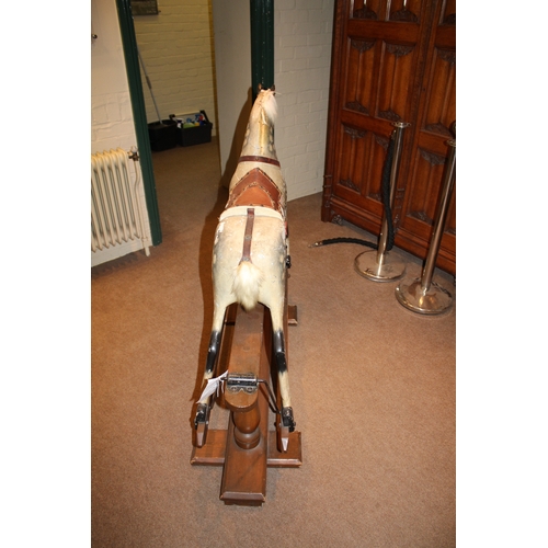 1413 - ANTIQUE ROCKING HORSE a painted wooden rocking horse, fitted with a leather saddle and stirrups and ... 