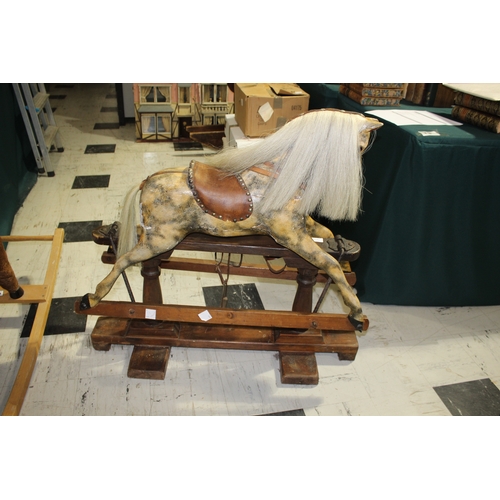 1416 - ANTIQUE ROCKING HORSE a small painted wooden rocking horse, mounted on a pine treadle base. Fitted w... 