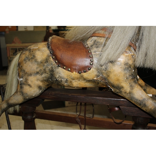 1416 - ANTIQUE ROCKING HORSE a small painted wooden rocking horse, mounted on a pine treadle base. Fitted w... 