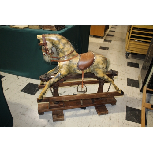 1416 - ANTIQUE ROCKING HORSE a small painted wooden rocking horse, mounted on a pine treadle base. Fitted w... 