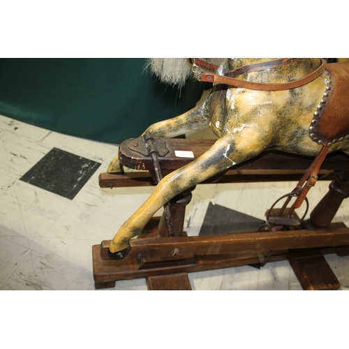 1416 - ANTIQUE ROCKING HORSE a small painted wooden rocking horse, mounted on a pine treadle base. Fitted w... 