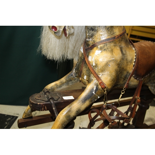 1416 - ANTIQUE ROCKING HORSE a small painted wooden rocking horse, mounted on a pine treadle base. Fitted w... 