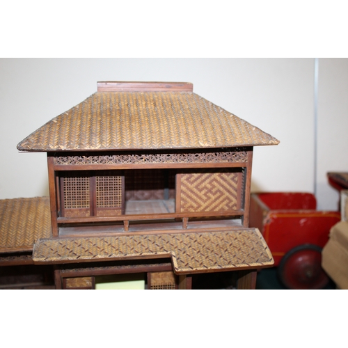 1466 - JAPANESE DOLLS HOUSE an early 20thc wood and wicker Japanese dolls house on stand, with an attached ... 