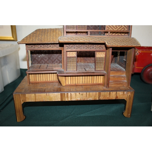 1466 - JAPANESE DOLLS HOUSE an early 20thc wood and wicker Japanese dolls house on stand, with an attached ... 