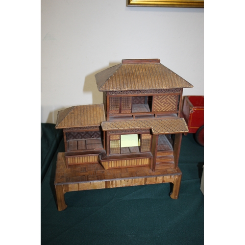 1466 - JAPANESE DOLLS HOUSE an early 20thc wood and wicker Japanese dolls house on stand, with an attached ... 