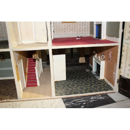 1481 - ANTIQUE DOLLS HOUSE a 2 storey house with large glazed windows and brick facade, the interior with f... 