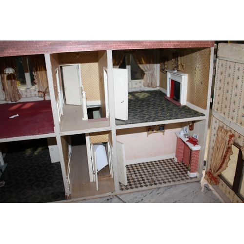 1481 - ANTIQUE DOLLS HOUSE a 2 storey house with large glazed windows and brick facade, the interior with f... 