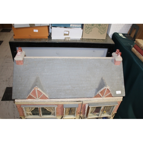 1481 - ANTIQUE DOLLS HOUSE a 2 storey house with large glazed windows and brick facade, the interior with f... 