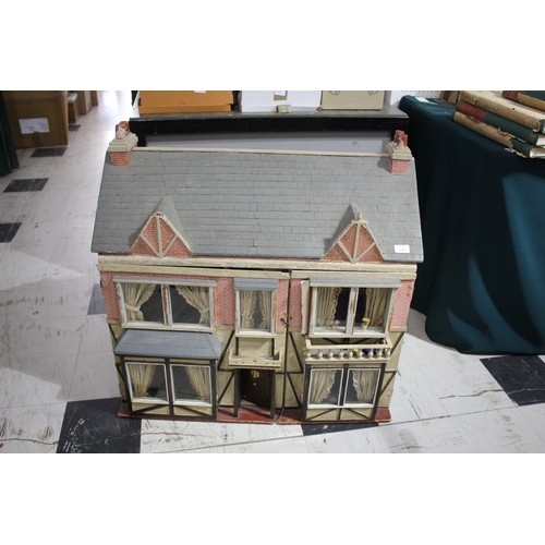 1481 - ANTIQUE DOLLS HOUSE a 2 storey house with large glazed windows and brick facade, the interior with f... 