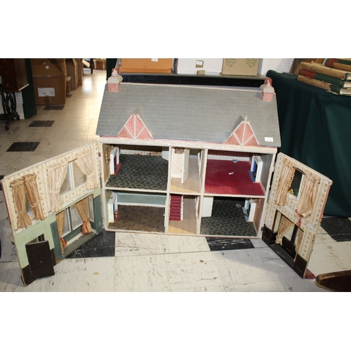 1481 - ANTIQUE DOLLS HOUSE a 2 storey house with large glazed windows and brick facade, the interior with f... 