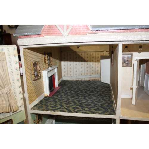 1481 - ANTIQUE DOLLS HOUSE a 2 storey house with large glazed windows and brick facade, the interior with f... 