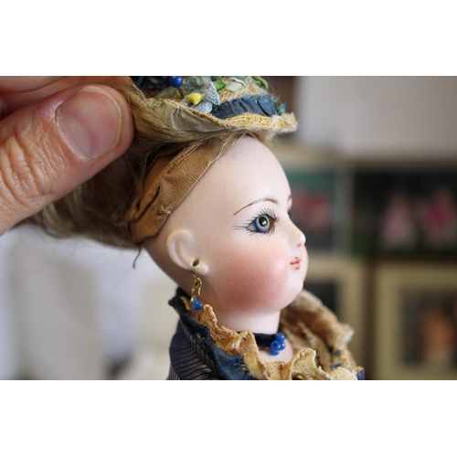 1507 - 19THC FRENCH FASHION DOLL a long faced French bisque head doll with swivel neck, with pale blue ring... 