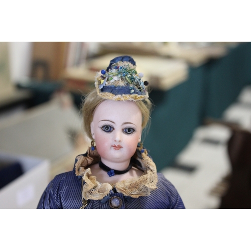 1507 - 19THC FRENCH FASHION DOLL a long faced French bisque head doll with swivel neck, with pale blue ring... 