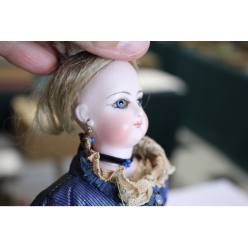 1507 - 19THC FRENCH FASHION DOLL a long faced French bisque head doll with swivel neck, with pale blue ring... 