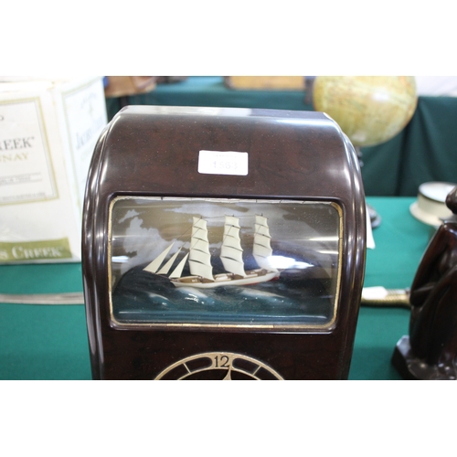 1563 - VITASCOPE BAKELITE SHIP CLOCK a Vitascope brown bakelite mantle clock, with an automated Ship (in wo... 