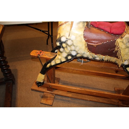 1392 - ANTIQUE ROCKING HORSE a painted wooden rocking horse, mounted on a wooden trestle base. 118cms high,... 