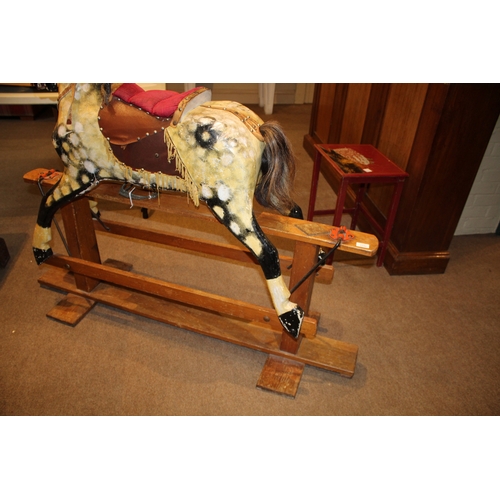 1392 - ANTIQUE ROCKING HORSE a painted wooden rocking horse, mounted on a wooden trestle base. 118cms high,... 