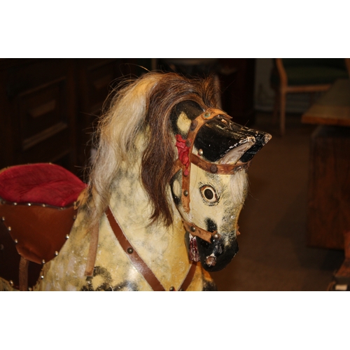 1392 - ANTIQUE ROCKING HORSE a painted wooden rocking horse, mounted on a wooden trestle base. 118cms high,... 