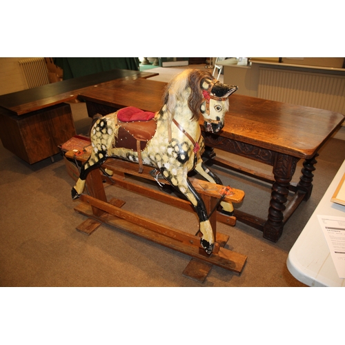 1392 - ANTIQUE ROCKING HORSE a painted wooden rocking horse, mounted on a wooden trestle base. 118cms high,... 