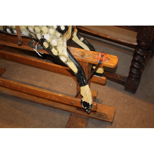 1392 - ANTIQUE ROCKING HORSE a painted wooden rocking horse, mounted on a wooden trestle base. 118cms high,... 