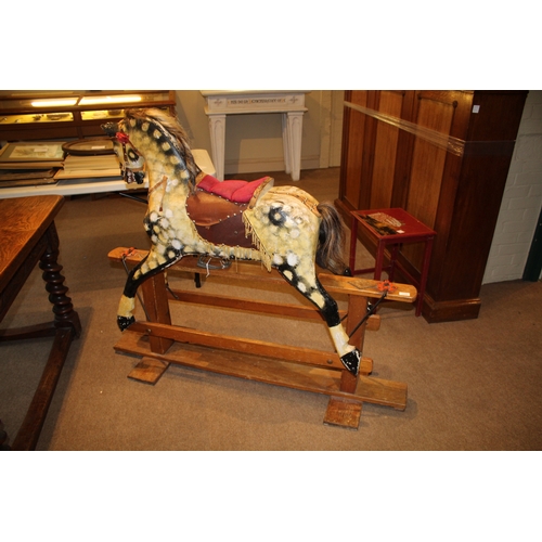 1392 - ANTIQUE ROCKING HORSE a painted wooden rocking horse, mounted on a wooden trestle base. 118cms high,... 