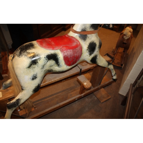 1402 - HADDON ROCKING HORSE a large fibreglass rocking horse, fitted with a saddle and bridle and mounted o... 