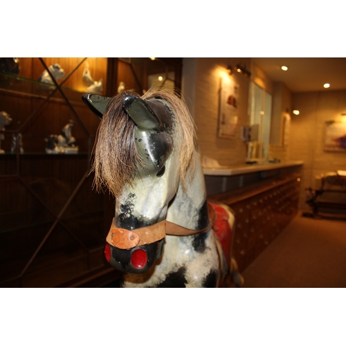 1402 - HADDON ROCKING HORSE a large fibreglass rocking horse, fitted with a saddle and bridle and mounted o... 