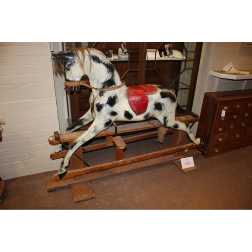 1402 - HADDON ROCKING HORSE a large fibreglass rocking horse, fitted with a saddle and bridle and mounted o... 