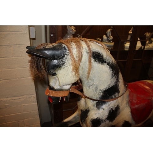 1402 - HADDON ROCKING HORSE a large fibreglass rocking horse, fitted with a saddle and bridle and mounted o... 