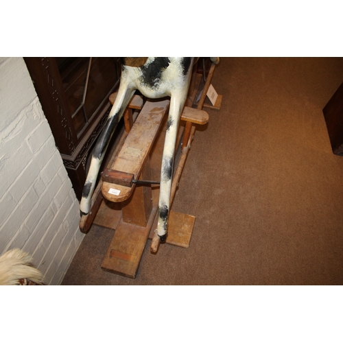 1402 - HADDON ROCKING HORSE a large fibreglass rocking horse, fitted with a saddle and bridle and mounted o... 