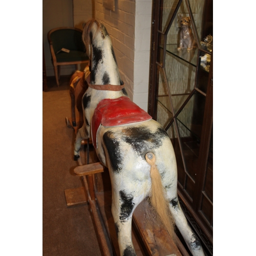 1402 - HADDON ROCKING HORSE a large fibreglass rocking horse, fitted with a saddle and bridle and mounted o... 