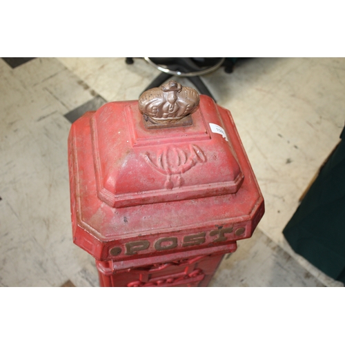 1565 - CAST IRON POST BOX a red painted cast iron pillar post box mounted with a crown to the top, marked P... 