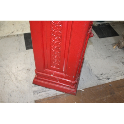 1565 - CAST IRON POST BOX a red painted cast iron pillar post box mounted with a crown to the top, marked P... 