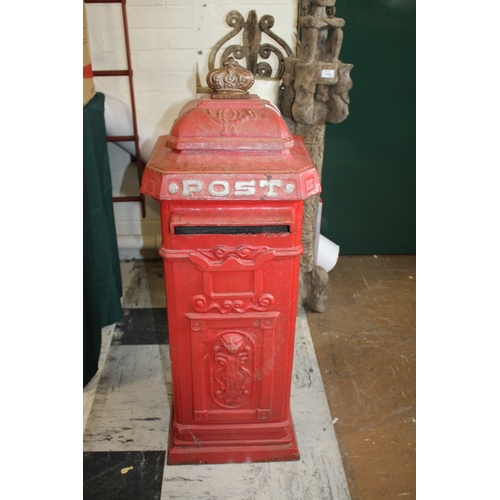 1565 - CAST IRON POST BOX a red painted cast iron pillar post box mounted with a crown to the top, marked P... 