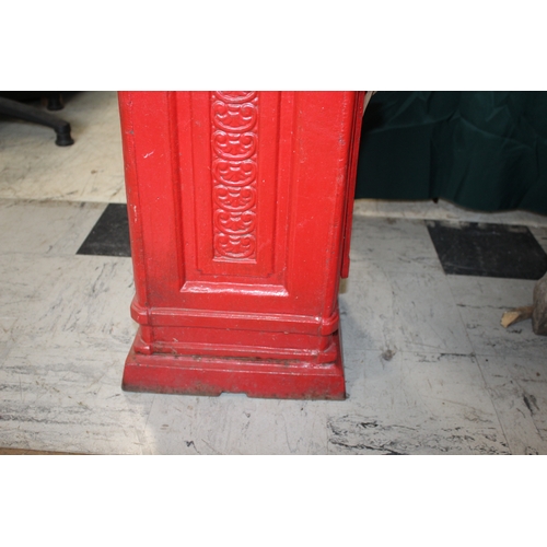 1565 - CAST IRON POST BOX a red painted cast iron pillar post box mounted with a crown to the top, marked P... 