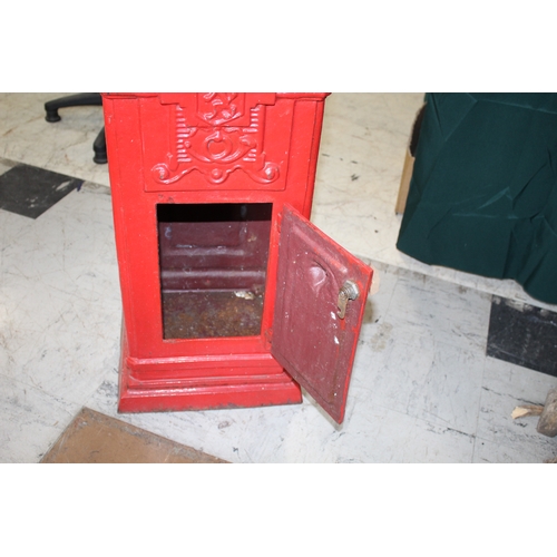 1565 - CAST IRON POST BOX a red painted cast iron pillar post box mounted with a crown to the top, marked P... 