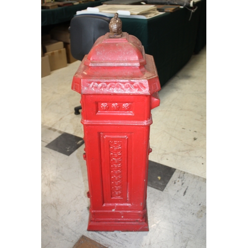 1565 - CAST IRON POST BOX a red painted cast iron pillar post box mounted with a crown to the top, marked P... 