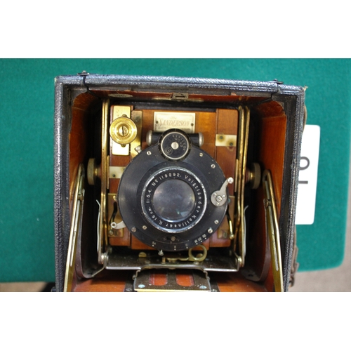 1548 - SANDERSON PLATE CAMERA a small mahogany and leather clad plate camera, with a Voigtlander Kollinear ... 