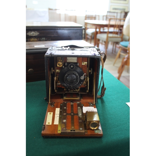 1548 - SANDERSON PLATE CAMERA a small mahogany and leather clad plate camera, with a Voigtlander Kollinear ... 