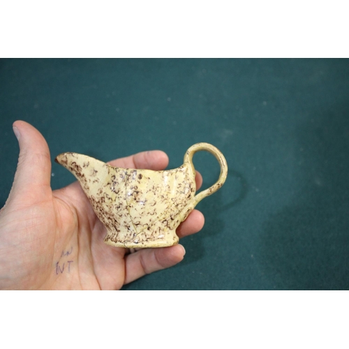 1368A - WHIELDON STYLE CREAMWARE BUTTER BOAT late 18th century, with brown sponged decoration, length 12cm; ... 