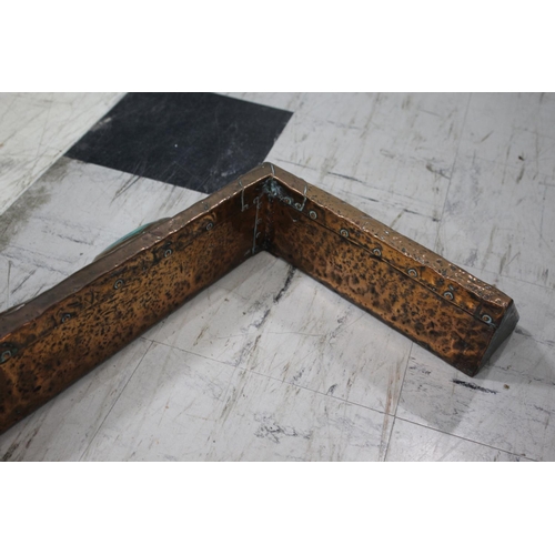 1025 - ARTS & CRAFTS COPPER FENDER a hand beaten fender with exposed rivets, with three Ruskin style rounde... 