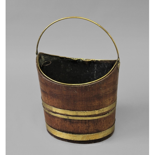 1700 - A GEORGE III MAHOGANY BRASS-BOUND BUCKET, with a brass liner and swing handle, and three horizontal ... 